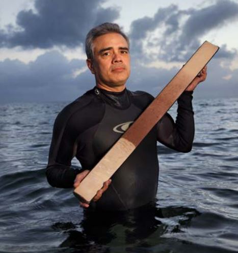 Paleoceanographer James Zachos holds a replica of a sediment core that shows an abrupt change in the Atlantic Ocean 56 million years ago, at the onset of the Paleocene-Eocene Thermal Maximum (PETM). White plankton shells vanished from the seafloor mud, shifting its color from white to red.